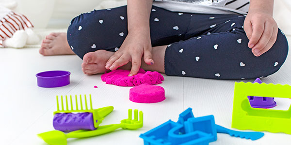 photo of child playing with plastic blocks 