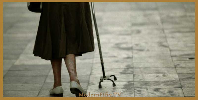senior women alone with a cane