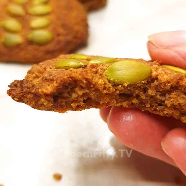 Low Carb Pumpkin Spice Cookies - KETO 11 hand holding bitten pumpkin spice cookie