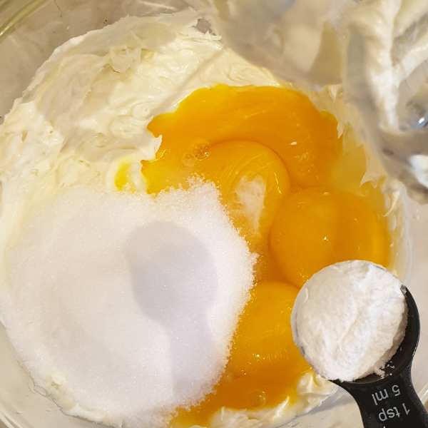 Combine egg yolks with cream cheese baking powder and sweetener